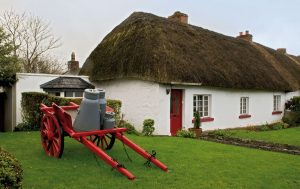 Day Trips 2 Shannon Airport taxis recommends Strolling through the Village of Adare to take in the beauty of the Thatched Cottages pictured here by Adare Manor 